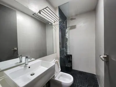 a white bathroom with a sink and a toilet at Georgetown Modern CosyStay in George Town