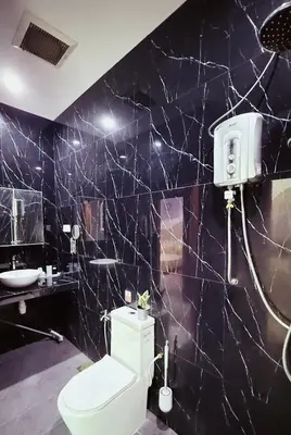 a bathroom with a toilet and a sink at Mimi 1 Bedroom Studio House Homestay in Gerik