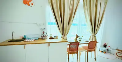 a kitchen with a table and chairs next to a window at Mimi 1 Bedroom Studio House Homestay in Gerik