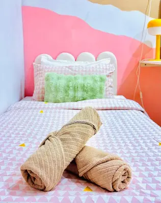 a bedroom with a bed with a towel on it at Mimi 1 Bedroom Studio House Homestay in Gerik
