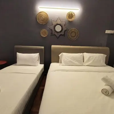 two beds sitting next to each other in a room at TG103a Pet Friendly 15pax, near beach side in Tanjung Bungah