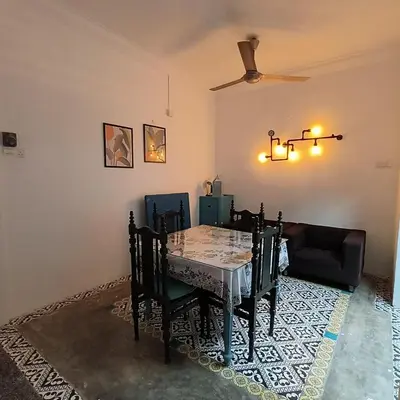 a dining room with a table and a couch at TG103a Pet Friendly 15pax, near beach side in Tanjung Bungah