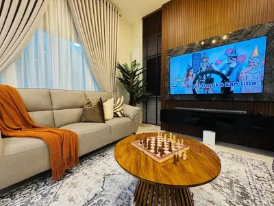 a living room with a couch and a table with chess at MSprivate Pool-Ipoh Perak in Ipoh
