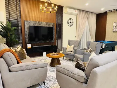 a living room with couches and a flat screen tv at MSprivate Pool-Ipoh Perak in Ipoh