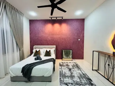 a bedroom with a large bed with a purple wall at MSprivate Pool-Ipoh Perak in Ipoh