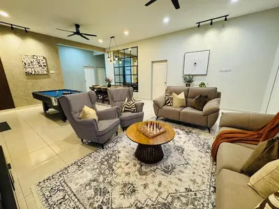 a living room with couches and a pool table at MSprivate Pool-Ipoh Perak in Ipoh
