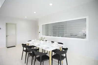 a white dining room with a white table and black chairs at GeorgeTown Codrington 6BR KTV BBQ Pool Bungalow 28Pax in George Town