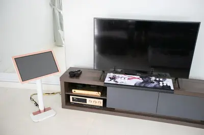 a living room with a flat screen tv on a entertainment center at GeorgeTown Codrington 6BR KTV BBQ Pool Bungalow 28Pax in George Town