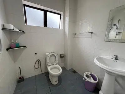 a white bathroom with a toilet and a sink at Cottage Hill -Cameron Highlands in Cameron Highlands