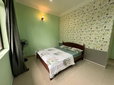 a small bedroom with a bed with a floral wallpaper at Cottage Hill -Cameron Highlands in Cameron Highlands