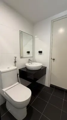 a bathroom with a white toilet and a sink at Haus in George Town