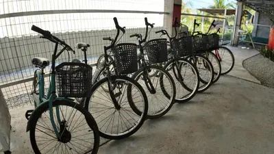 a row of bikes parked next to a fence at Love UU Garden - Paddy View Stay with Bicycle Ride in Balik Pulau