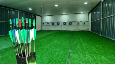 a room with green grass and baseball bats at Love UU Garden - Paddy View Stay with Bicycle Ride in Balik Pulau