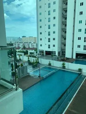 a swimming pool on the roof of a building at Straits Garden Suites in Jelutong