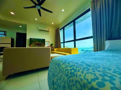 a bedroom with a bed and a large window at Big screen cinema tv, 5 queen bed Luxury apt 2cp in Jelutong