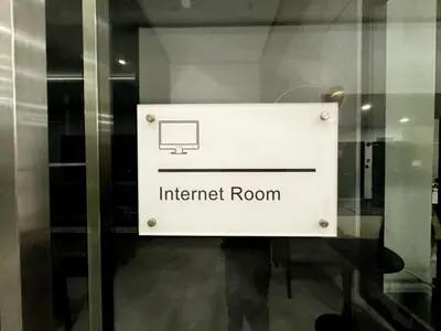 a sign for an internet room on a glass door at Big screen cinema tv, 5 queen bed Luxury apt 2cp in Jelutong