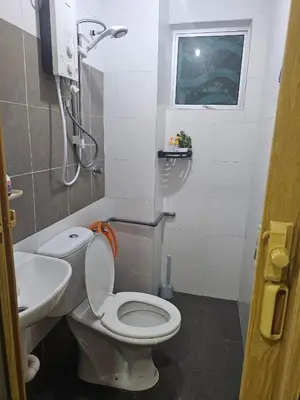a small bathroom with a toilet and a sink at Mikayla Homestay in Ipoh