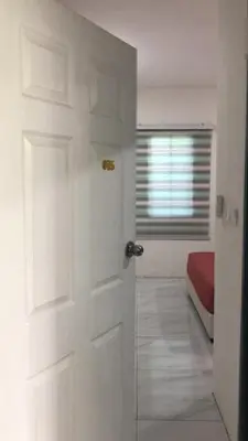 a white door in a room with a bed at Skyn 2 smartstay in Ipoh