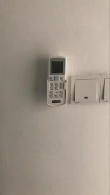 a cell phone on a wall next to a microwave at Skyn 2 smartstay in Ipoh