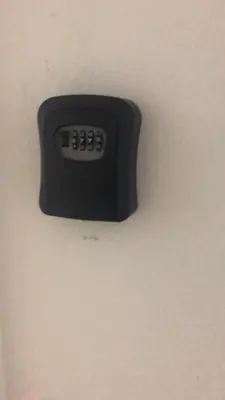 a black clock on a white wall at Skyn 2 smartstay in Ipoh