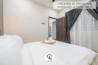 a white bed with a phone on top of it at IPOH CAIP TownHouse UpperUnit 4R3B Ipoh Tambun 10Pax by Luvit Stay in Ipoh