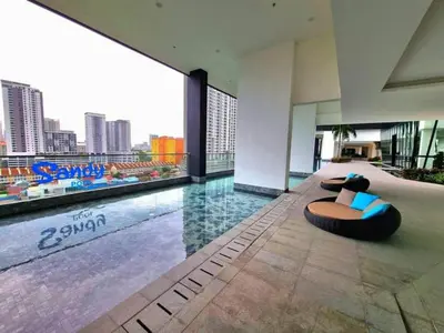 a hotel lobby with a pool with a chaise lounge at CoZY FAMILY STAY GEORGETOWN 3BR -10PAX URBAN in Jelutong