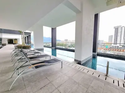 a row of chairs in a building with a pool at CoZY FAMILY STAY GEORGETOWN 3BR -10PAX URBAN in Jelutong