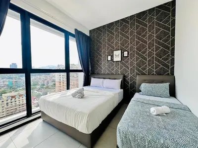 a bedroom with two beds and a large window at CoZY FAMILY STAY GEORGETOWN 3BR -10PAX URBAN in Jelutong