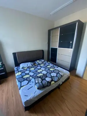 a bedroom with a bed in a room with a window at Bright Apartment in Klebang in Ipoh