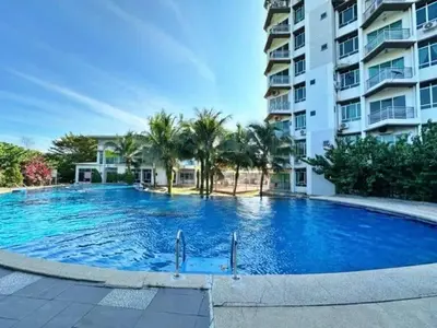 a large swimming pool in front of a building at Bright Apartment in Klebang in Ipoh