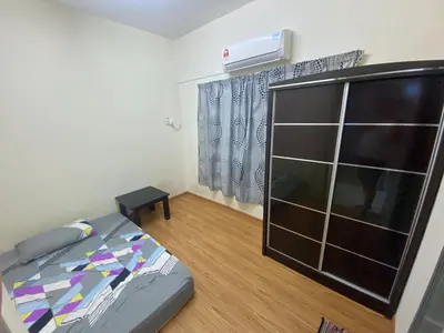 a bedroom with a bed and a dresser in it at Bright Apartment in Klebang in Ipoh