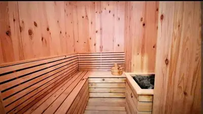 a sauna with wooden walls and a wooden floor at a29 seaview luxury 3BR-10PAX URBAN NETFLIX in Jelutong