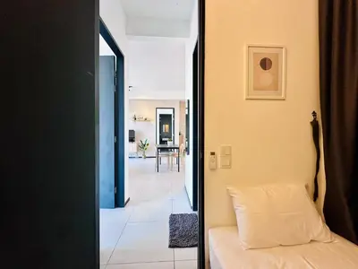a room with a bed and a hallway at a29 seaview luxury 3BR-10PAX URBAN NETFLIX in Jelutong