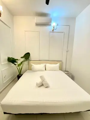 a white bed with a white bow on it at Seahome Boutique Hotel in Tanjung Bungah