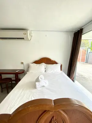 a bed with a white towel on top of it at Seahome Boutique Hotel in Tanjung Bungah