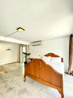 a bedroom with a wooden bed in a room at Seahome Boutique Hotel in Tanjung Bungah