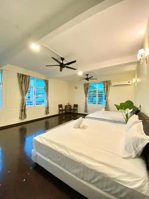 a bedroom with two beds and a ceiling fan at Seahome Boutique Hotel in Tanjung Bungah
