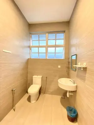 a bathroom with a toilet and a sink and a window at Seahome Boutique Hotel in Tanjung Bungah