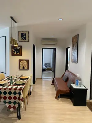 a living room with a table and a couch at 118 Island Plaza by ZenZone88 in Tanjong Tokong
