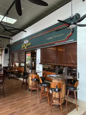 a restaurant with tables and chairs in a room at 118 Island Plaza by ZenZone88 in Tanjong Tokong