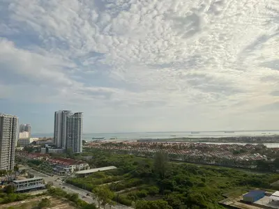 a view of a city with buildings and the ocean at 118 Island Plaza by ZenZone88 in Tanjong Tokong