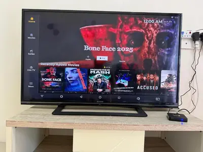 a large screen tv sitting on top of a table at Bright Apartment in Klebang in Ipoh