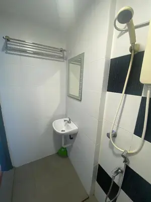 a bathroom with a sink and a mirror at Bright Apartment in Klebang in Ipoh