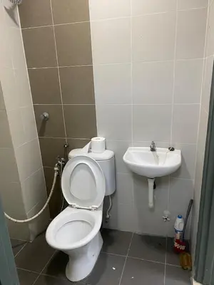 a bathroom with a toilet and a sink at Bright Apartment in Klebang in Ipoh