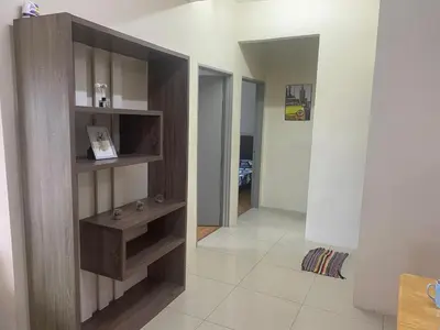 a living room with a sink and a hallway at Bright Apartment in Klebang in Ipoh