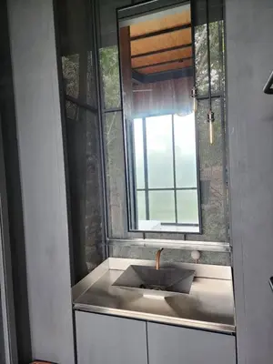 a bathroom with a sink and a window at The Wildwood Retreat KKB in Kuala Kubu Baharu
