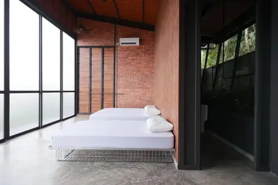 two white beds in a room with large windows at The Wildwood Retreat KKB in Kuala Kubu Baharu