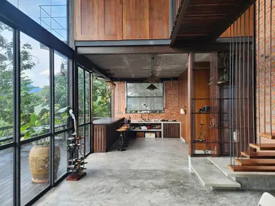 an open kitchen with glass doors and a brick wall at The Wildwood Retreat KKB in Kuala Kubu Baharu