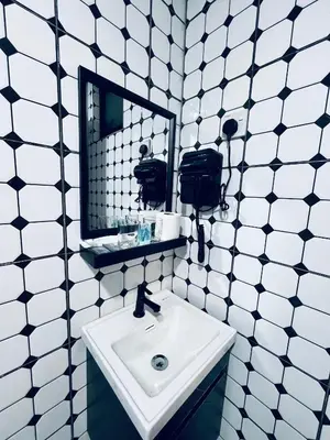 a bathroom with a sink and a mirror at Big Dreams Hotel in Tanah Rata