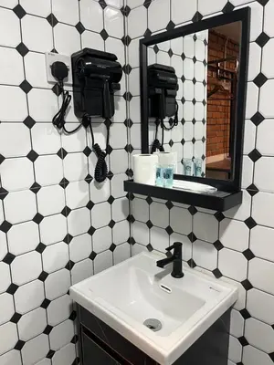 a bathroom with a sink and a mirror at Big Dreams Hotel in Tanah Rata